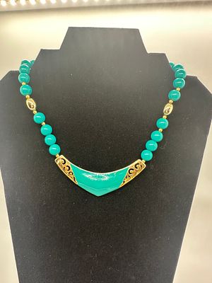 Turquoise and Gold-Tone Chevron Pendant Necklace. A turquoise and gold-tone necklace featuring 