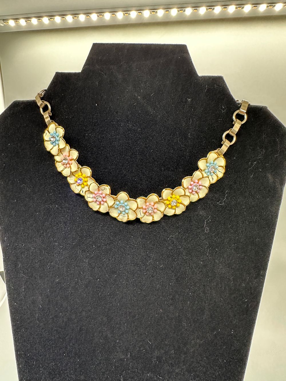 Gold Tone Enamel Flower Necklace with Beaded Centers. A gold-tone necklace featuring multiple 