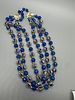 Triple Strand Blue Faceted and Gold Toned Filigree Bead Necklace. A triple-strand necklace Image - 1