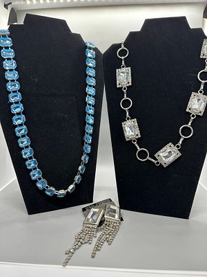 A Trio of Costume Jewelry Necklaces and Earrings. A collection featuring a light blue 