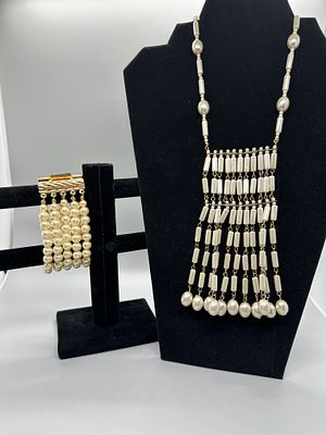 A Pair of Faux Pearl Jewelry Items. A cream-colored faux pearl multi-strand bib necklace and a 