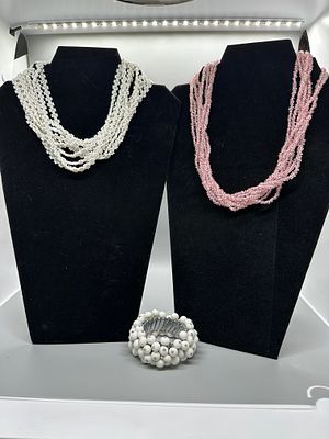 A Trio of Beaded Necklaces and Bracelet. A trio of jewelry pieces including a multi-strand pink 