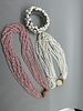 A Trio of Beaded Necklaces and Bracelet. A trio of jewelry pieces including a multi-strand pink Image - 1
