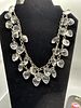 Two Pieces of Fashion Jewelry. A silver-tone chain necklace featuring clear heart-shaped charms Image - 1