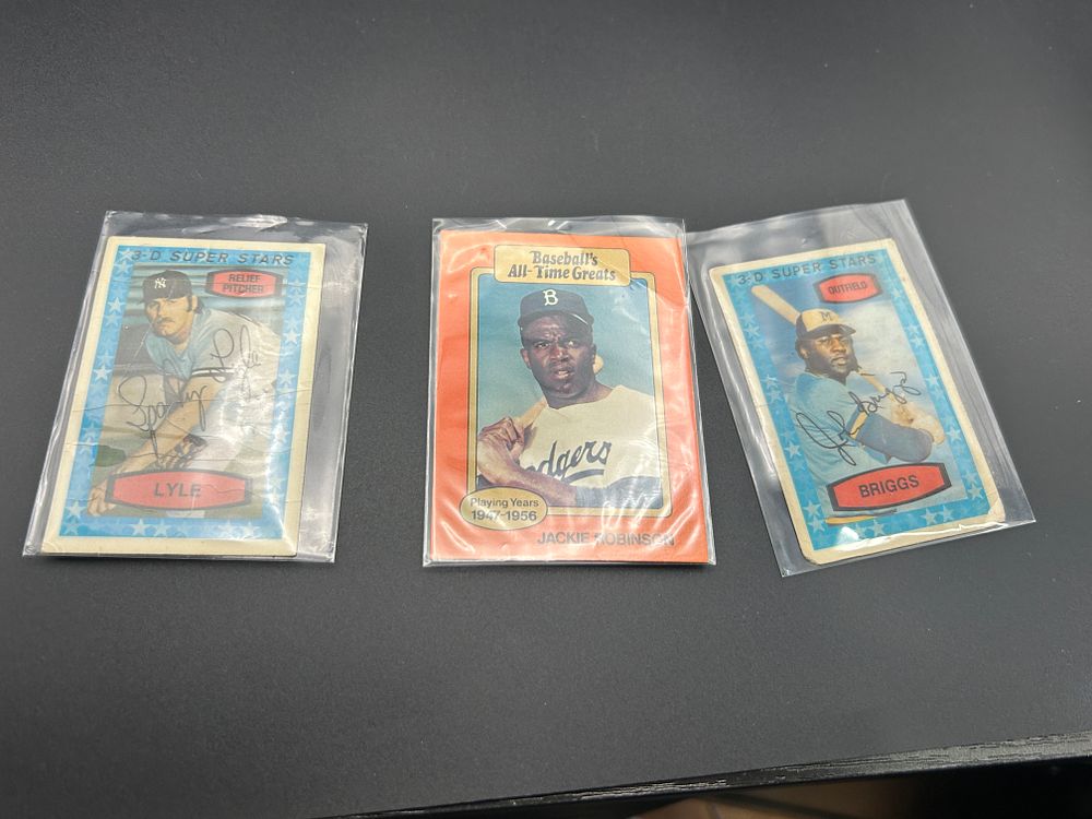 Lot 154: A Trio of Vintage 1970s Baseball Cards featuring Jackie Robinson Sparky Lyle and Johnny Briggs