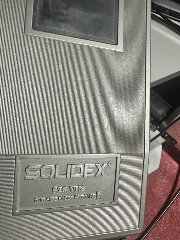 JVC VCR/DVD combo with Tape rewinder and assorted media on sheves
