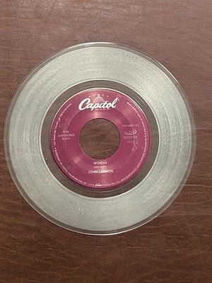 John Lennon “Woman” Clear 45 RPM Record. Capitol 72438-58965-7-8 jukebox-only record featuring 