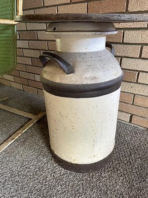 Repurposed Milk Can. has attached top to be used as a side table or plant stand.No Shipping