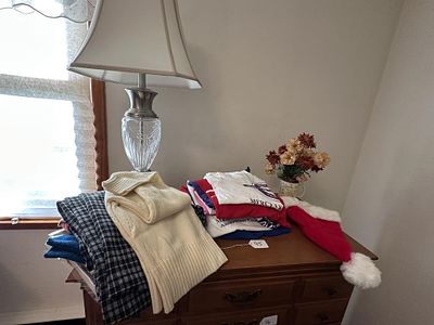 Contents of Top of Dresser. incl stack of vintage Breast Cancer fundraiser graphic t-shirts and 