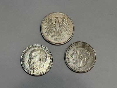 A collection of three coins from the period of Nazi Germany.