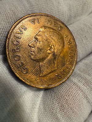 A 1 penny coin from South Africa, dated 1942.