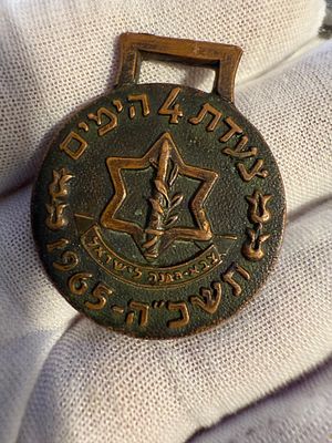 A bronze military medal issued to commemorate the Four Days March, dated 1965.
