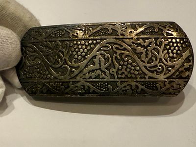 Large rectangular clasp made of silver-tone metal, richly decorated with engraved motifs of 
