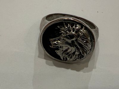 Bold signet ring featuring a three-dimensional relief of a lion’s head in profile, creating a 