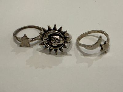 Lot of three fashion rings featuring celestial-inspired designs, with motifs of stars, the moon 