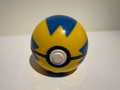 An official TOMY Pok&eacute;mon Quick Ball — the yellow-and-blue zigzag-patterned Pok&eacute; Ball with white 