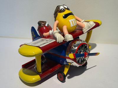 Vintage M&amp;M's biplane collectible – Yellow and Red characters in an aviator airplane. This 