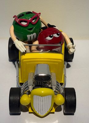 Vintage M&amp;M's hot rod collectible – Green and Red characters riding in a yellow roadster. 