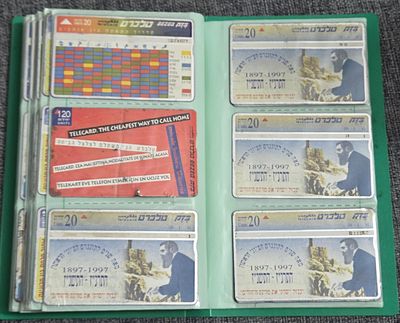 Green collector's album containing 120 telephone cards, primarily Israeli Bezeq Telecard issues 