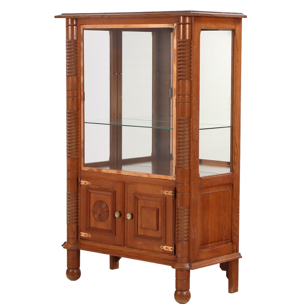 FRENCH OAK TWO DOOR CABINET HAVING COPPER PLATED BRASS DOOR AND GEOMETRIC MOTIFS IN THE MANNER OF. 