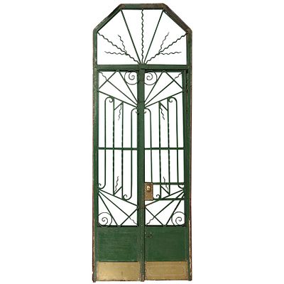 A PAIR OF ART DECO IRON GATES WITH TRANSOM AND FRAME C 1930. A pair of Art Deco iron gates with 