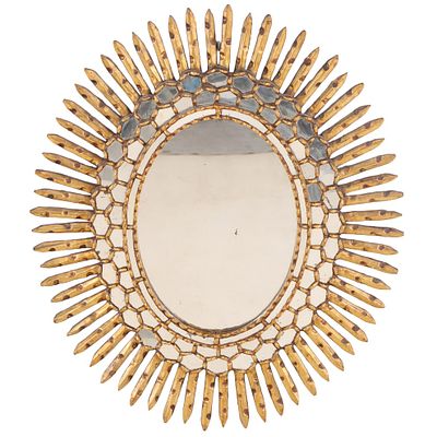 A SPANISH STYLE CARVED AND GILTWOOD STARBURST MIRROR CIRCA 1970. A Spanish style carved and 