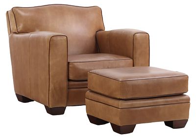 A LEATHER CLUB CHAIR AND OTTOMAN IN THE MANNER OF JEAN-MICHEL FRANK BY HENREDON. A leather club 