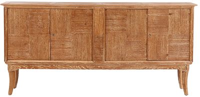 A FOUR DOOR CERUSED OAK SIDEBOARD HAVING SUBTLE PATCHWORK DESIGN AND FOUR INTERIOR DRAWERS C 1945. 