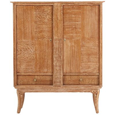 A TWO DOOR CERUSED OAK BAR CABINET C 1945. A two door cerused oak bar cabinet C 1945. Ht: 