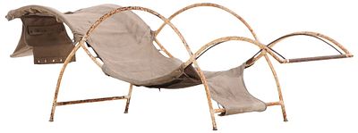 A FRENCH IRON AND CANVAS CHAISE LOUNGE IN THE MANNER OF RENE PROU C 1940. A french iron and 