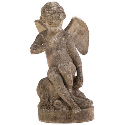FRENCH CAST STONE GARDEN FIGURE OF A WINGED CHERUB AT REST C 1940. French cast stone garden 