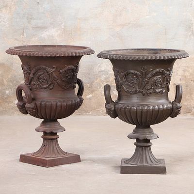 PAIR OF NINETEENTH CENTURY CAST IRON CAMPAGNA FORM GARDEN URNS HAVING HANDLES WITH MALE MASKS AND. 