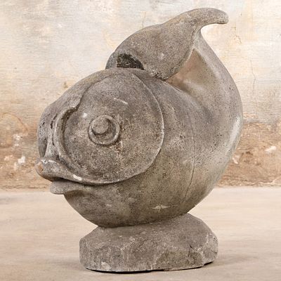 A WHIMSICAL CAST STONE GARDEN FIGURE DEPICTING A FISH C 1960. A whimsical cast stone garden 