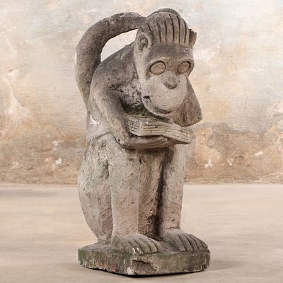 A WHIMSICAL CAST STONE GARDEN FIGURE DEPICTING A MONKEY C 1960. A whimsical cast stone garden 