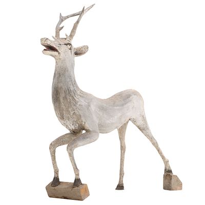 A CAST STONE FIGURE OF A REINDEER PAINTED TO LOOK LIKE ZINC. A cast stone figure of a reindeer 