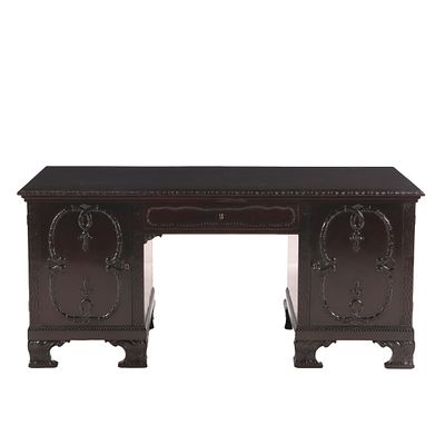 CHIPPENDALE STYLE MAHOGANY FLAT TOP DESK HAVING TWO DOORS OPENING TO SHELVES AND A DRAWER C 1910. 