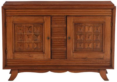 ONE OF TWO FRENCH OAK TWO DOOR SERVERS WITH GEOMETRIC MOTIFS IN THE MANNER OF DUDOUYT C 1940. On 