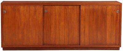 FIGURED WALNUT SIDEBOARD C 1950 HAVING THREE FAUX TAMBOUR SLIDING DOORS AND THE LEFT COMPARTMENT. 