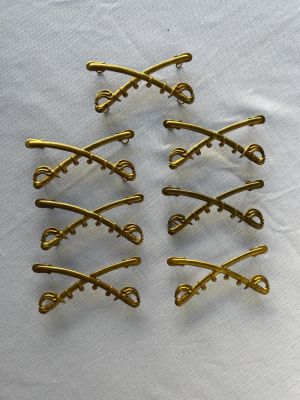 Indian Wars Cavalry Insignia. Lot of seven Indian wars cavalry cross swords, insignia for kepi. 