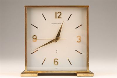 Van Cleef and Arpels Desk Clock. Battery operated desk clock in a brass case with Swiss 