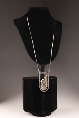 Jean-Claude Darveau Brutalist Pendant Necklace featuring a textured geometric pendant with faux 