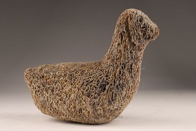 Inuit Fossilized Whale Bone Carving Bird Form. A stylized bird carved from fossilized whale bone 