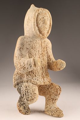 Large Fossilized Whale Bone Sculpture, Hunter Figure. A large Inuit carving of a hunter in a 