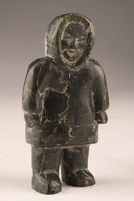 Small Inuit Carving of a Standing Figure. Stone carving, likely soapstone, depicting a standing 