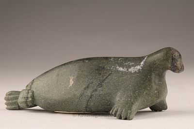 Inuit Stone Carving of a Seal, ca. mid-20th century. Carved in dark green stone, this compact 