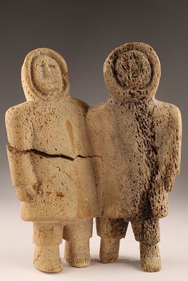 Inuit Carved Fossilized Bone Sculpture of Two Figures. A large Inuit carving in fossilized bone 