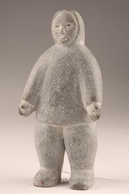 Inuit Stone Carving of a Standing Figure. A compact Inuit stone carving depicting a standing 
