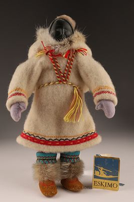 Inuit Doll with Stone Face and Original Guild Tag, Pond Inlet. A mid-20th century Inuit handmade 