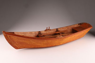 Folk Art Carving of a Row Boat with Two Oars, one oarlock is broken. Measuring 23 inches L x 5 