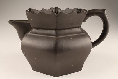 A Signed Dark Brown Chinese Yixing Clay Teapot. 
It features a distinctive lotus-shaped edge on 